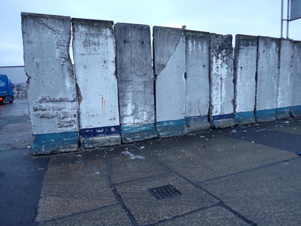 Slabs of the former Berlin Wall, now acting as retaining walls at a materials sorting facility.